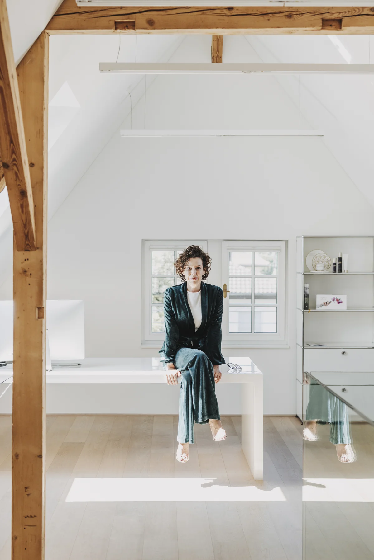 Barbara Sandner-Troll sitzt auf einem weißen Tisch 