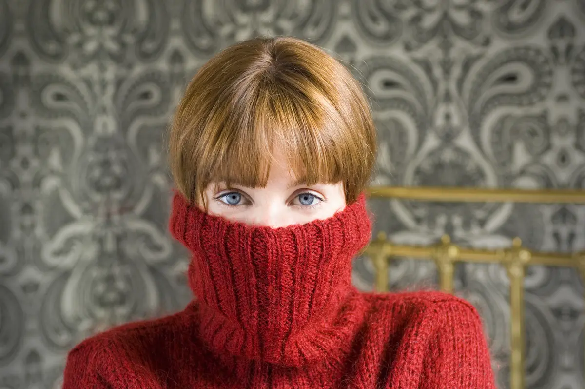 Frau mit roten Pullover über dem Gesicht