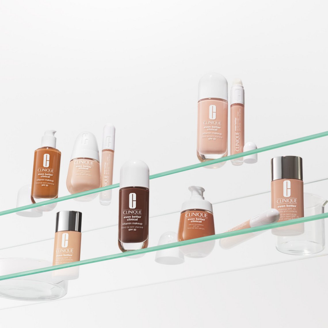 Clinique Even Better Foundation-Range in verschiedenen Hautfarben-Nuancen, arrangiert auf transparenten Glasablagen