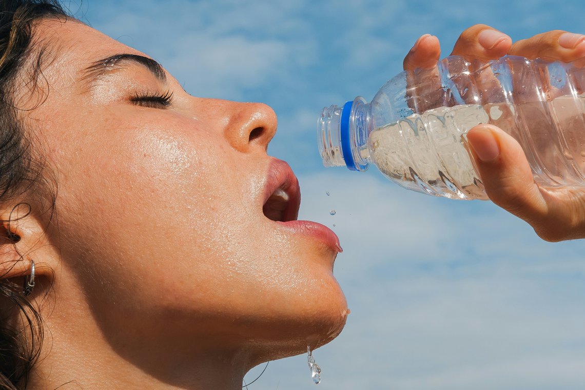 Porträt einer Frau im Sommer die Wasser trinkt