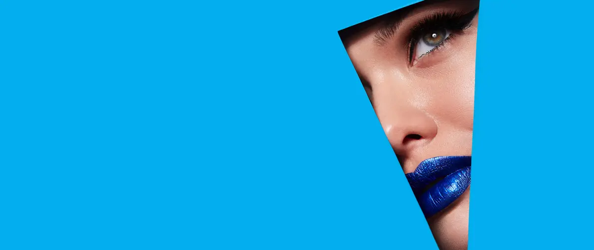 Frau mit blauem Lippenstift auf blauem Hintergrund