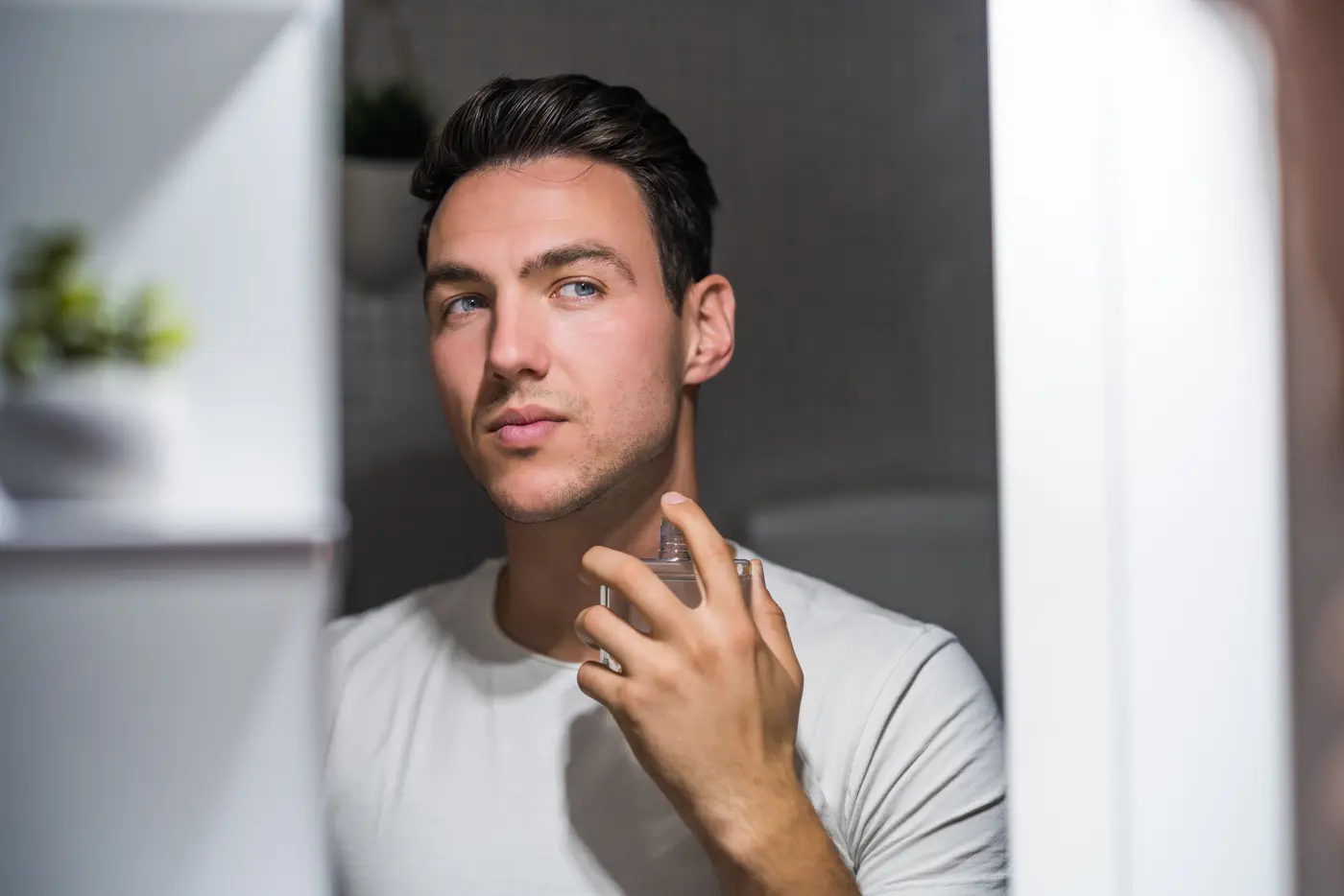 Mann im Bad mit Parfumflakon