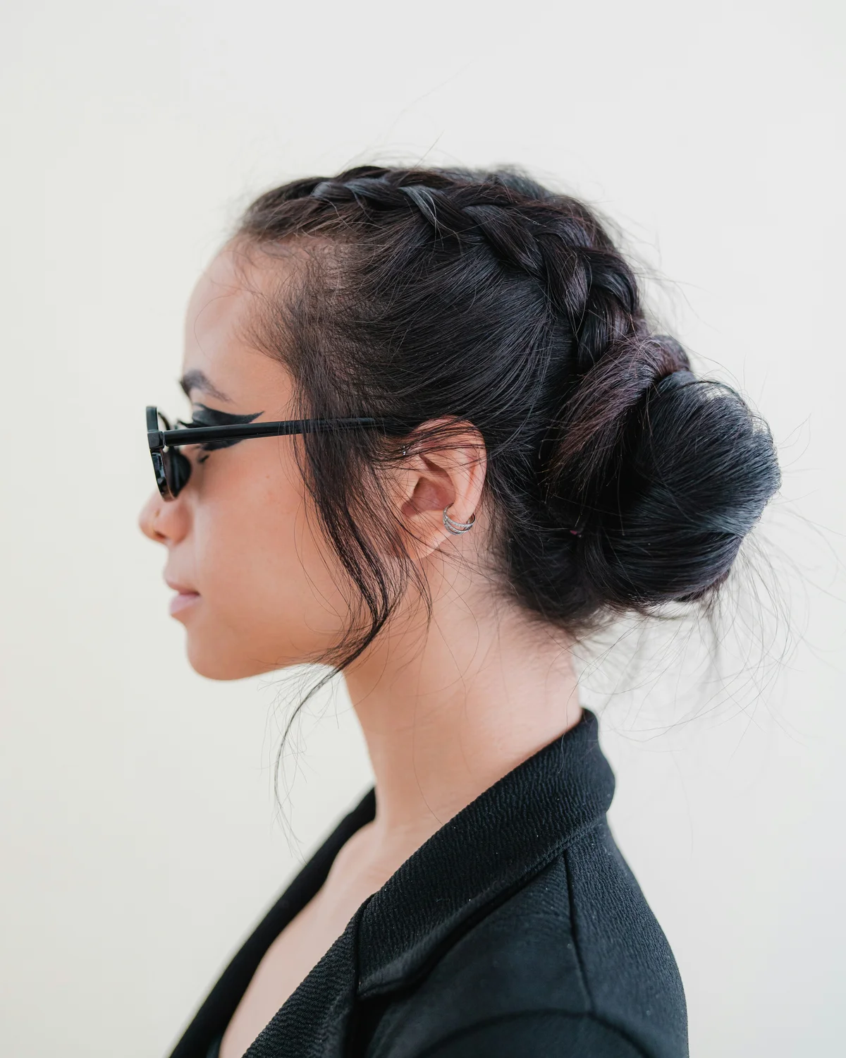 Coole junge Frau mit dunklen Haaren und Flechtfrisur