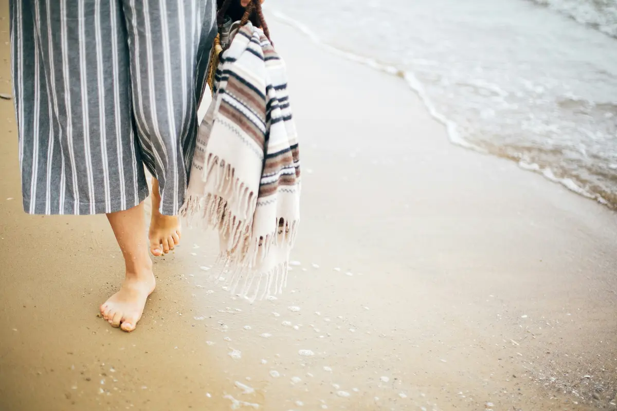 Junge Frau läuft Barfuß am Strand, Nahaufnahme Füße