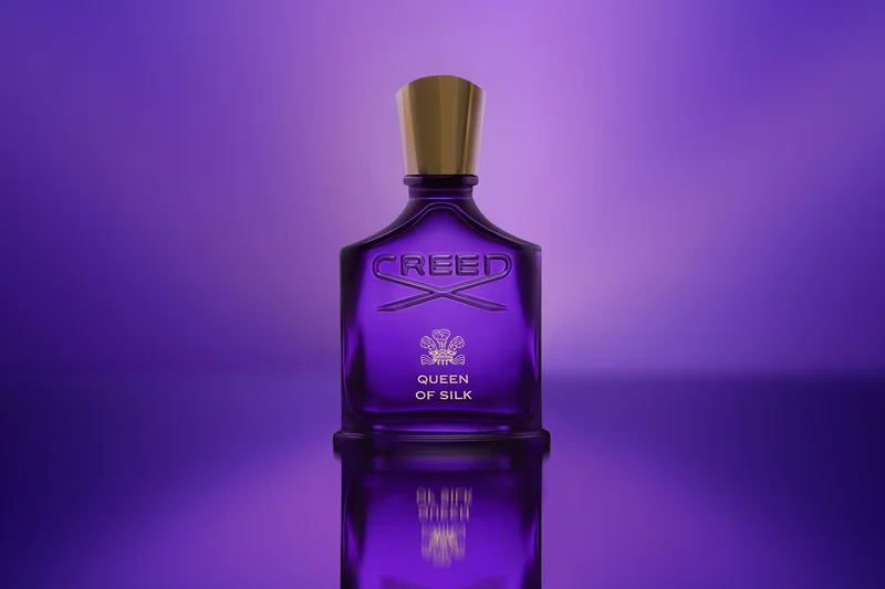 Parfum-Flakon von QUEEN OF SILK von CREED auf lilafarbenem Hintergrund